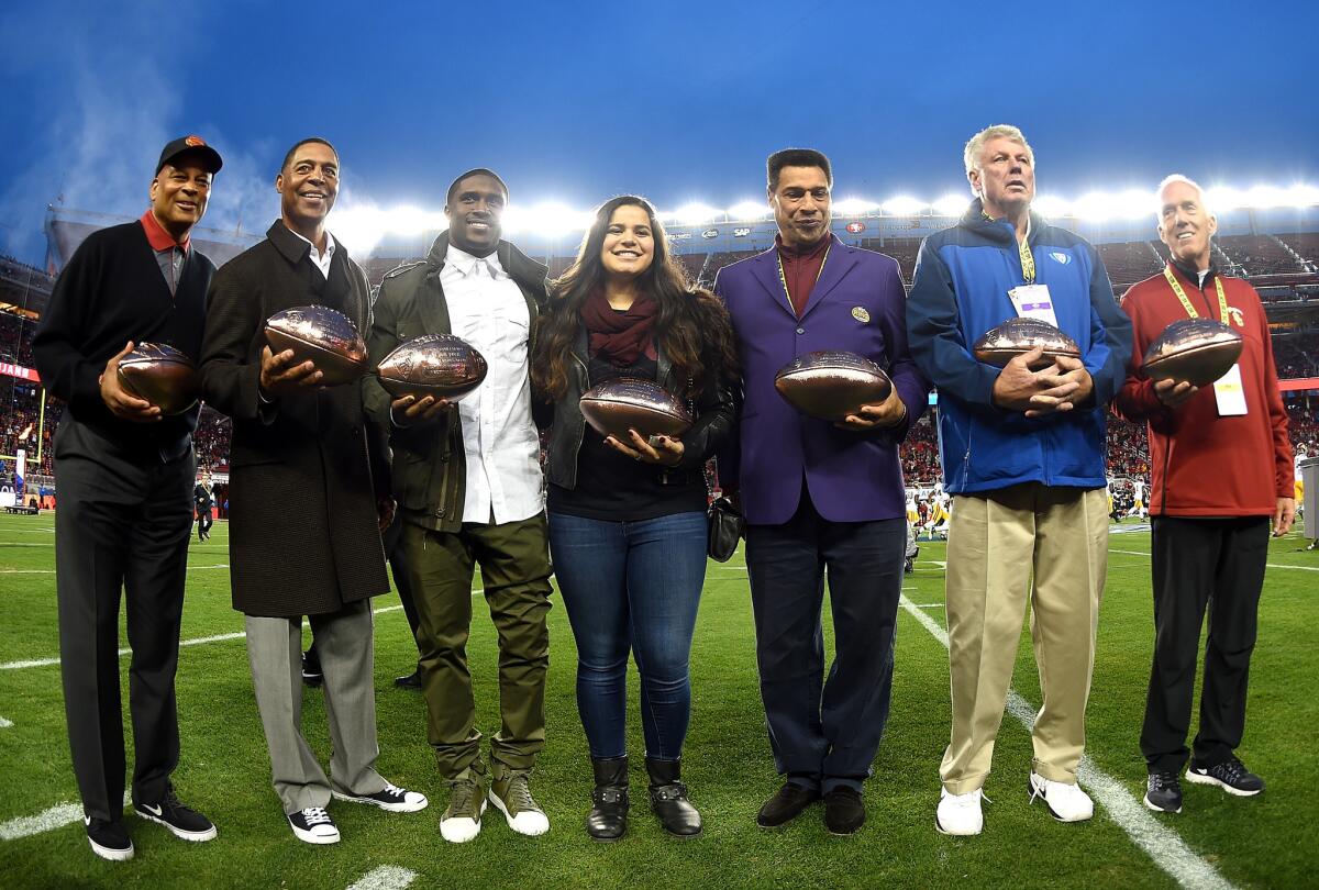 Members of the Pac-12 All Century Team Ronnie Lott, Marcus Allen, Reggie Bush, Sydney Seau representing her father Junior Seau, Joey Browner, Ron Yary, Jim McKay on behalf of his father John, pose for a photograph at the Pac-12 champioship game on Dec. 5.