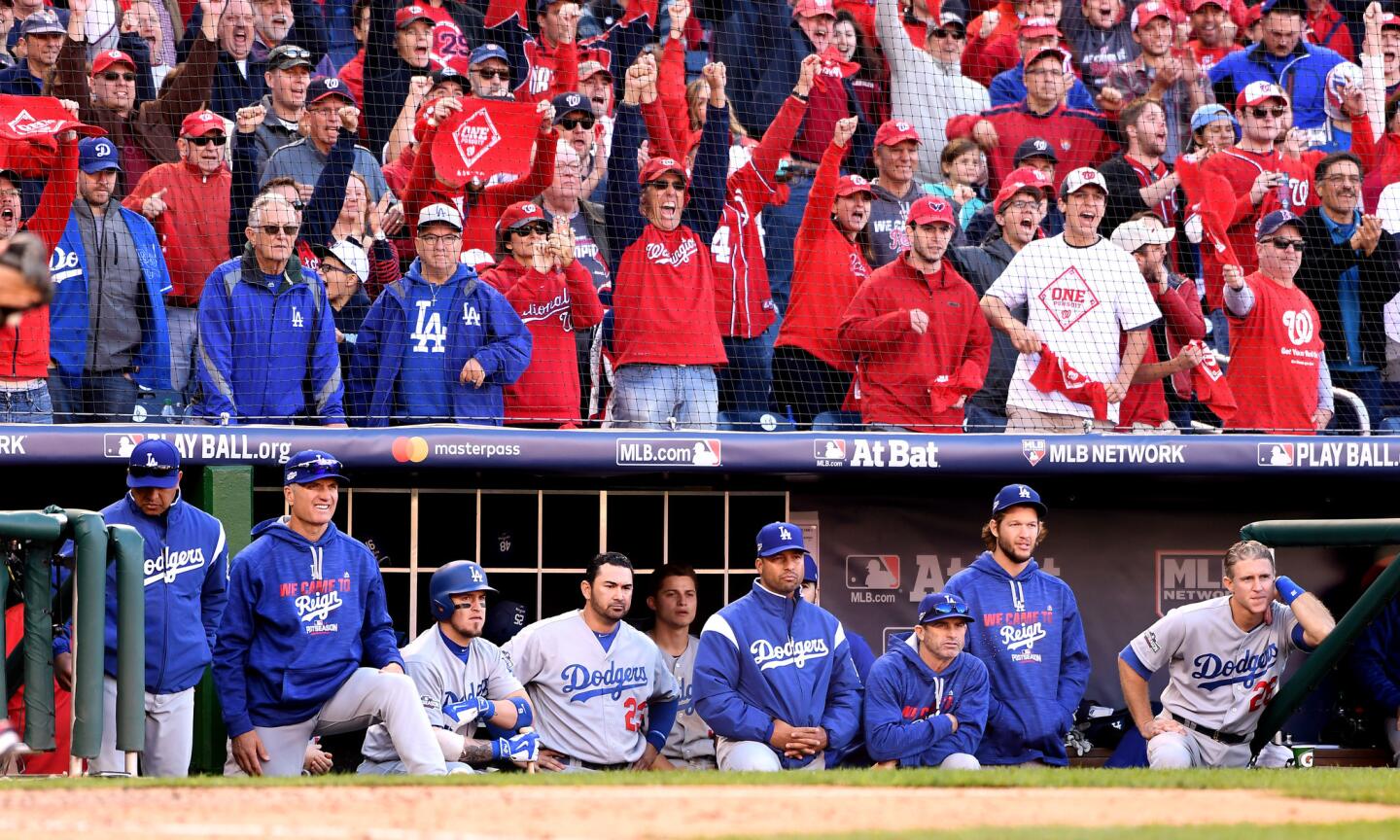 Fans celebrate at the end of the game as members of the Dodgers look on in Game 2.