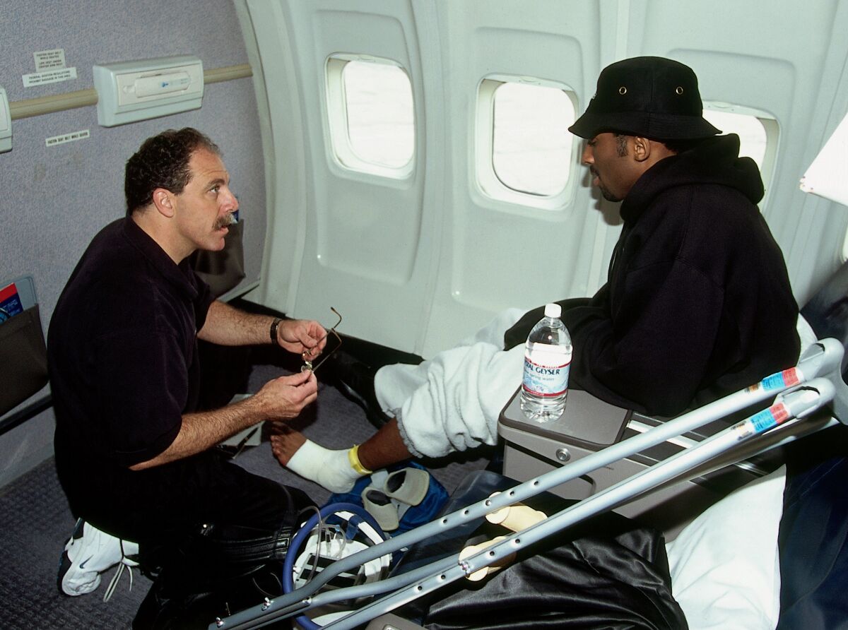 Gary Vitti treats Kobe Bryant on board the team flight to Indiana the day before Game 3 of the 2000 NBA Finals.