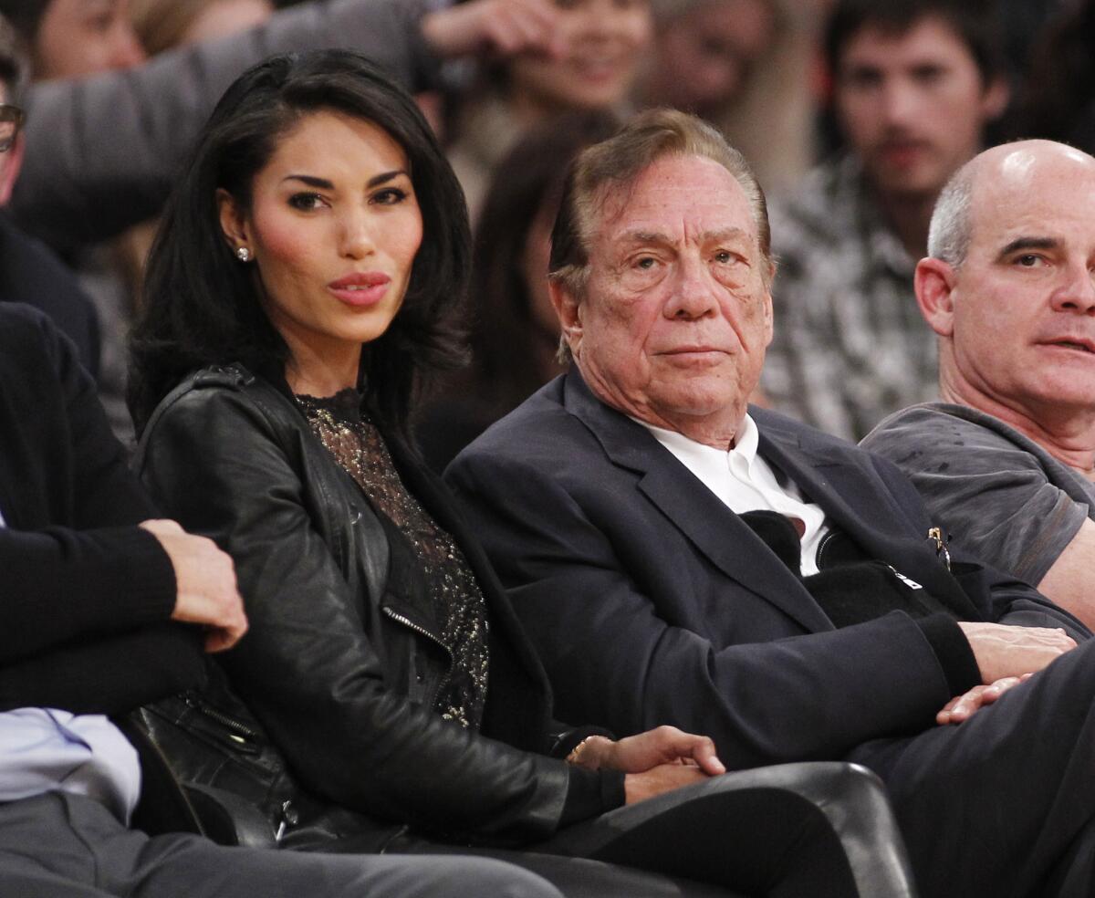 Los Angeles Clippers owner Donald Sterling, right, and V. Stiviano watch the Clippers play the Los Angeles Lakers during an NBA preseason basketball game in Los Angeles in 2010.
