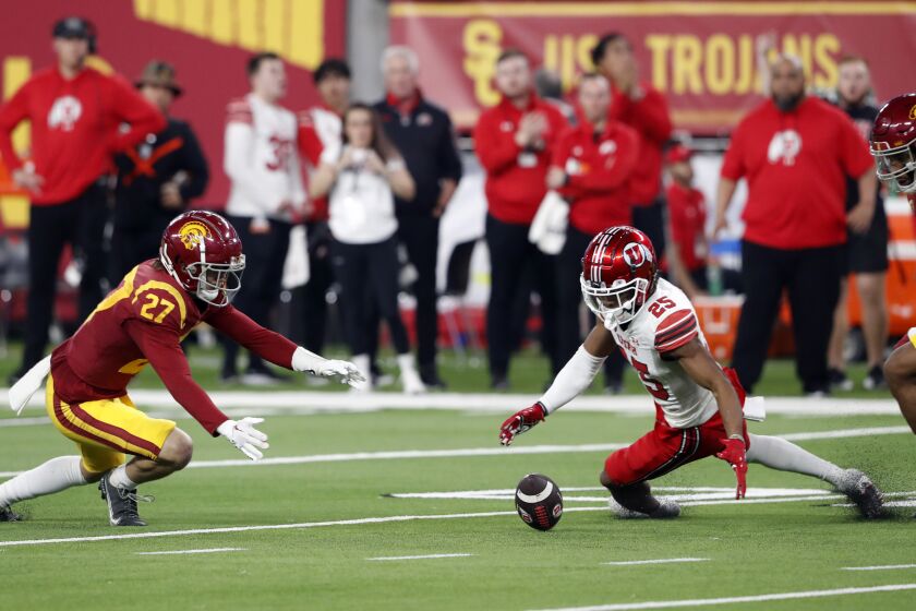 Utah wide receiver Jaylen Dixon (25) fumbles the ball during the first half of the Pac-12 Conference championship NCAA college football game against Southern California, Friday, Dec. 2, 2022, in Las Vegas. Southern California defensive back Bryson Shaw (27) recovered the fumble. (AP Photo/Steve Marcus)