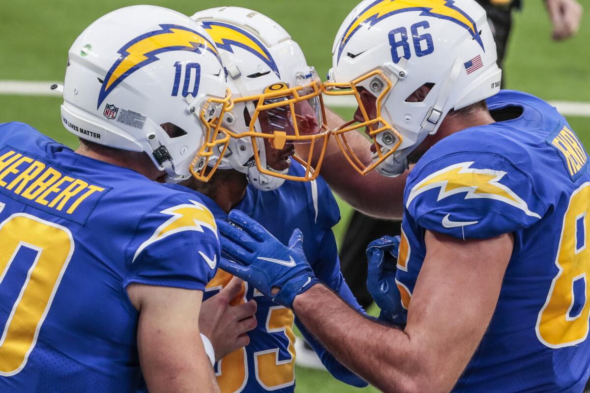 Chargers wide receiver Tyron Johnson is congratulated by teammates Hunter Henry and Justin Herbert.