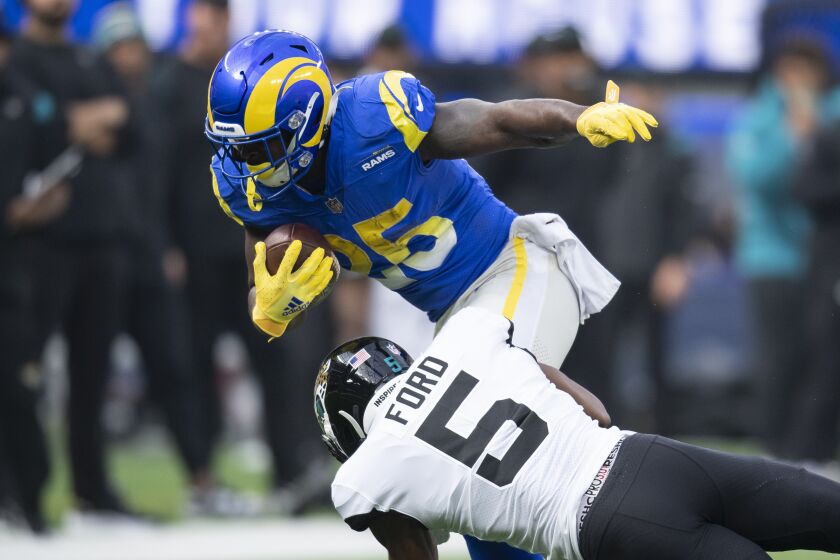 Los Angeles Rams running back Sony Michel (25) is tackled by Jacksonville Jaguars defensive back Rudy Ford.