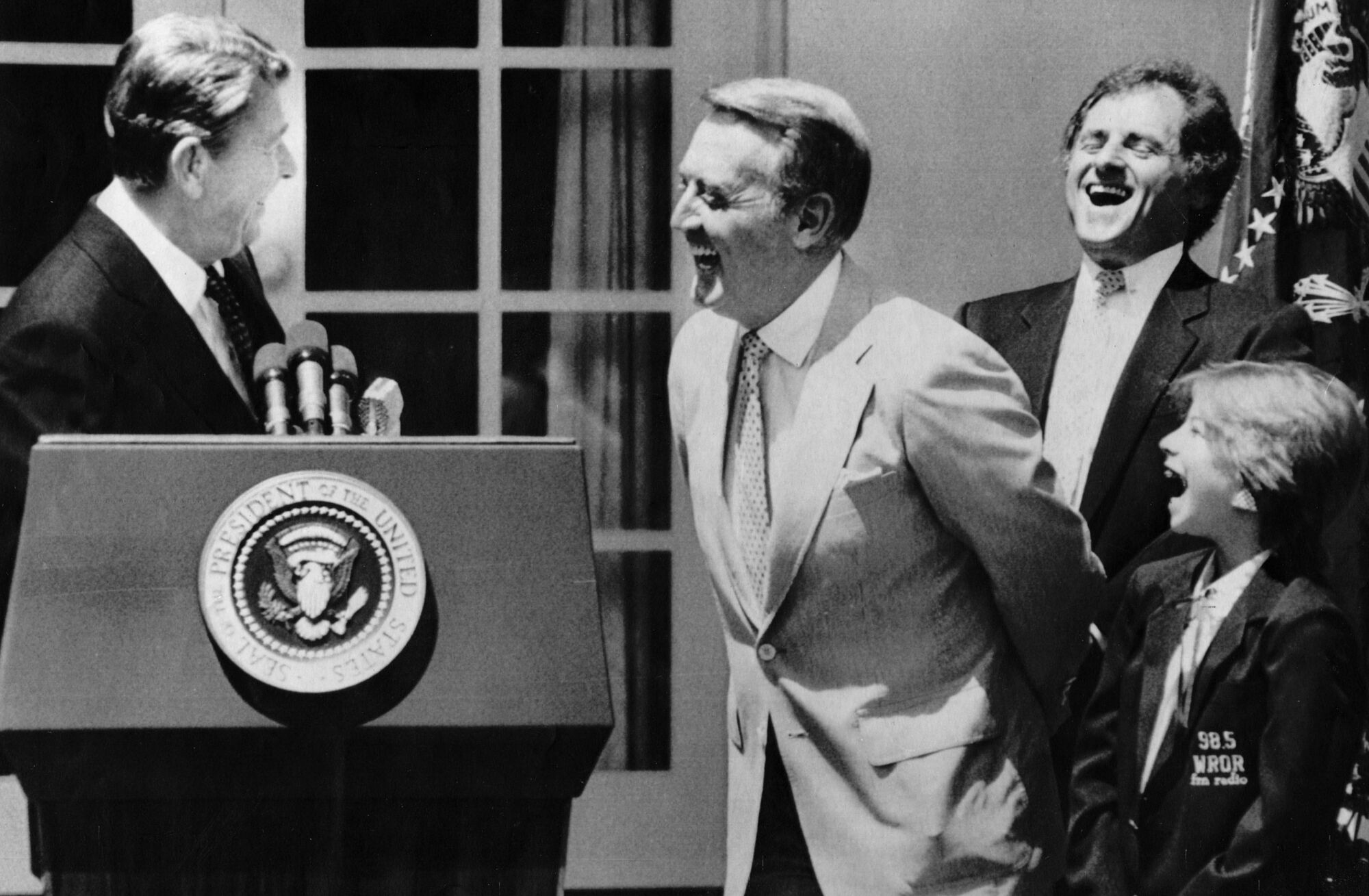 President Ronald Reagan enjoys a laugh with sportscasters Vin Scully, Warner Wolfe and Kelley Michelle of WROR Radio.