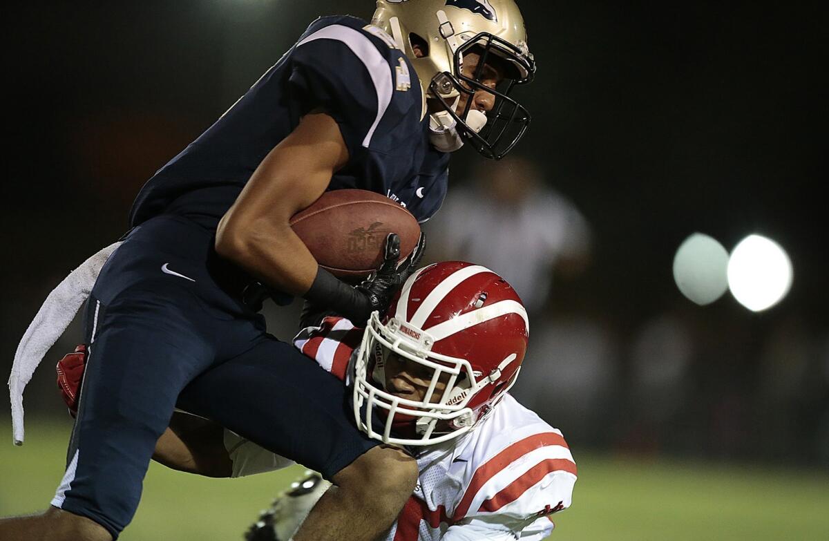 St. John Bosco and receiver Devin Fleming, getting tackled by Mater Dei defensive back Jalen Cole on Friday night, are back at No. 1 in the Southland after defeating the Monarchs, 28-25.
