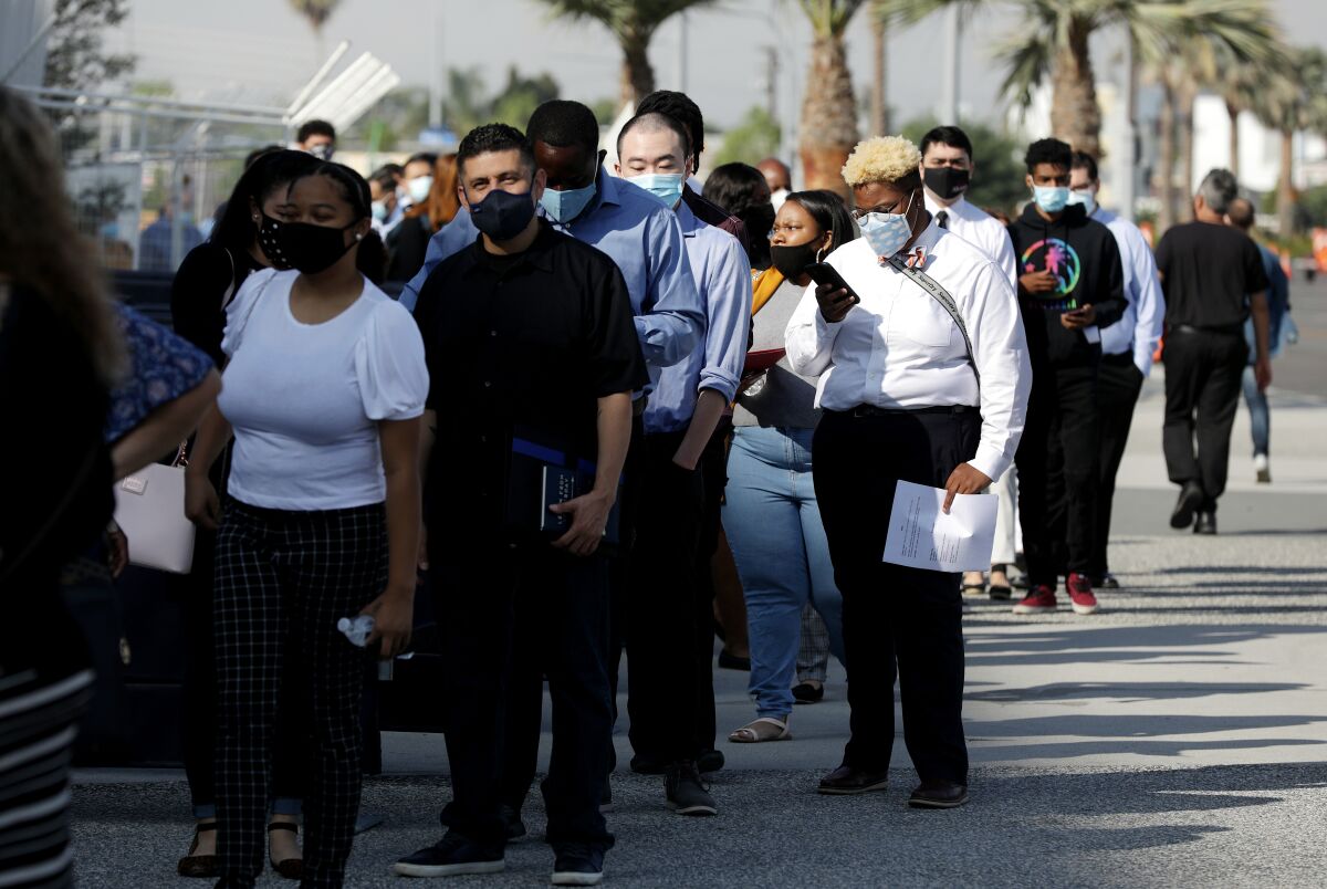 Applicants standing in line outside a job fair