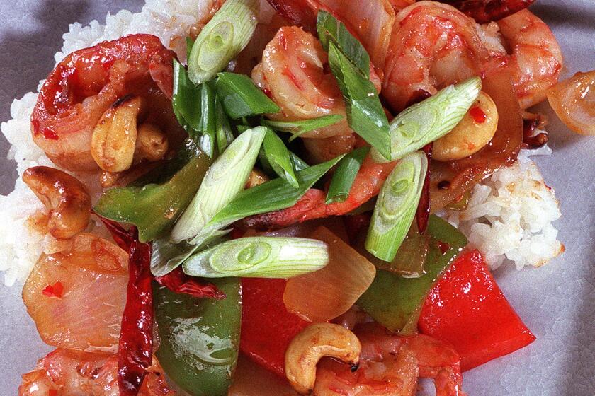 Kung Pao Shrimp, complete with bell peppers, green onions, chile garlic sauce and roasted cashews.