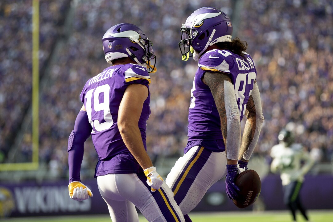 Minnesota Vikings tight end Tyler Conklin celebrates with wide receiver Adam Thielen in the end zone.