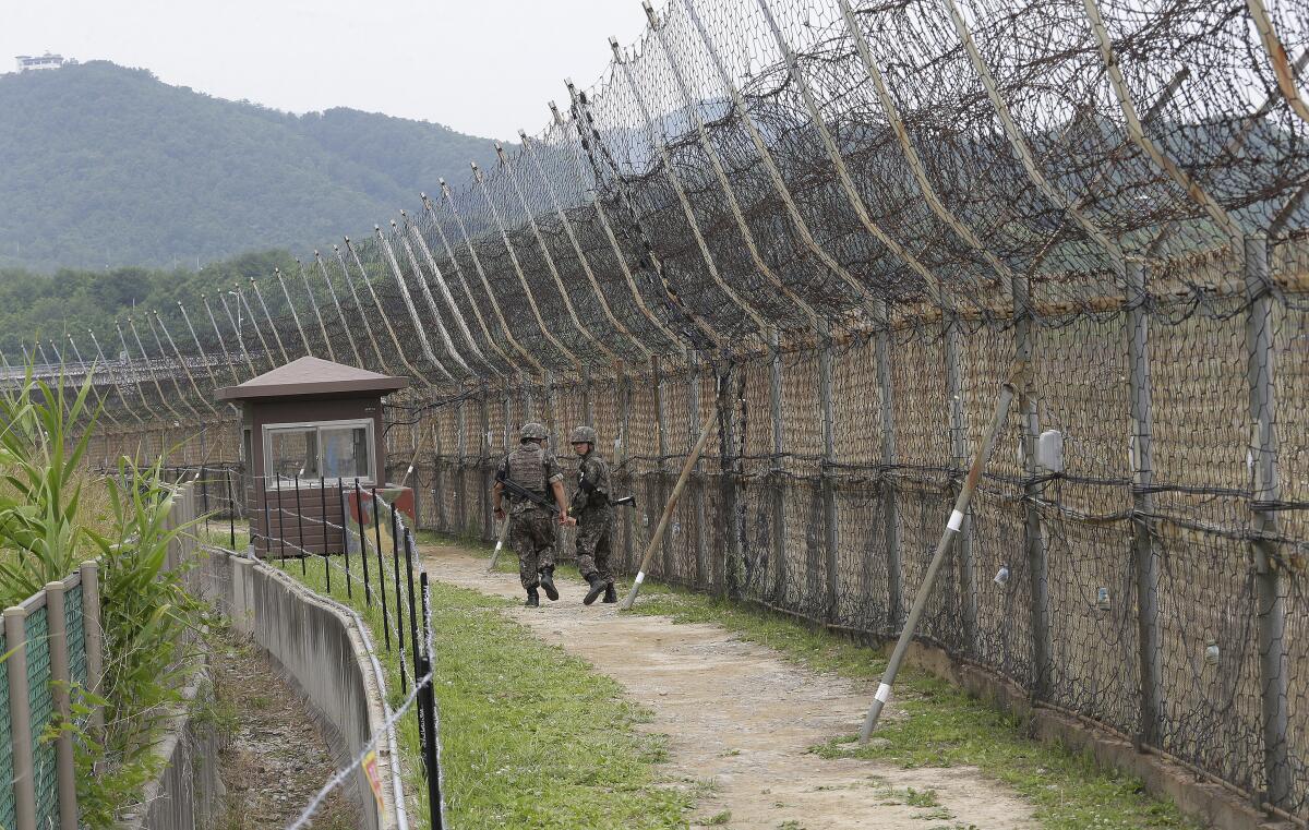 Two soldiers patrol the demilitarized zone in Goseong, South Korea. 