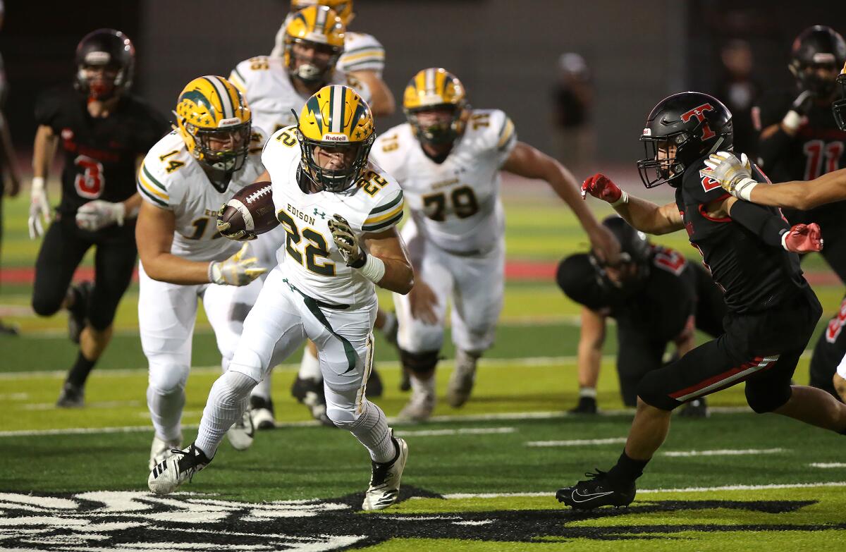 Edison's Tanner Nelson (22) is off to the races to complete a 29-yard touchdown run after breaking a tackle in a nonleague game at San Clemente on Friday.