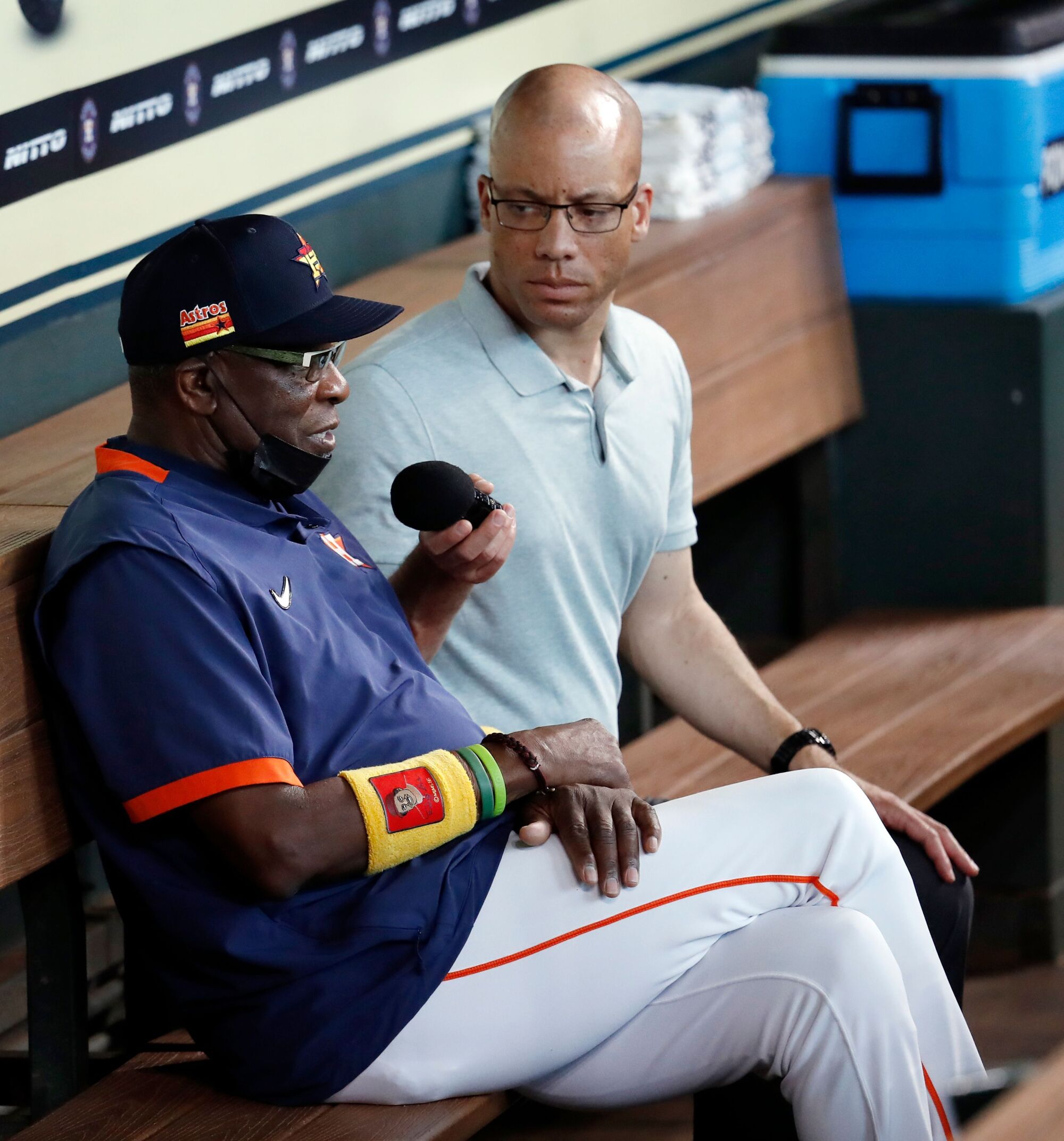 Astros manager Dusty Baker Jr. is interviewed by Robert Ford in the dugout before a game.