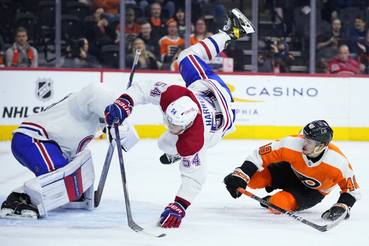 Montreal Canadiens' Jordan Harris (54) collides with Philadelphia Flyers' Morgan Frost (48) during the second period of an NHL hockey game, Tuesday, March 28, 2023, in Philadelphia. (AP Photo/Matt Slocum)
