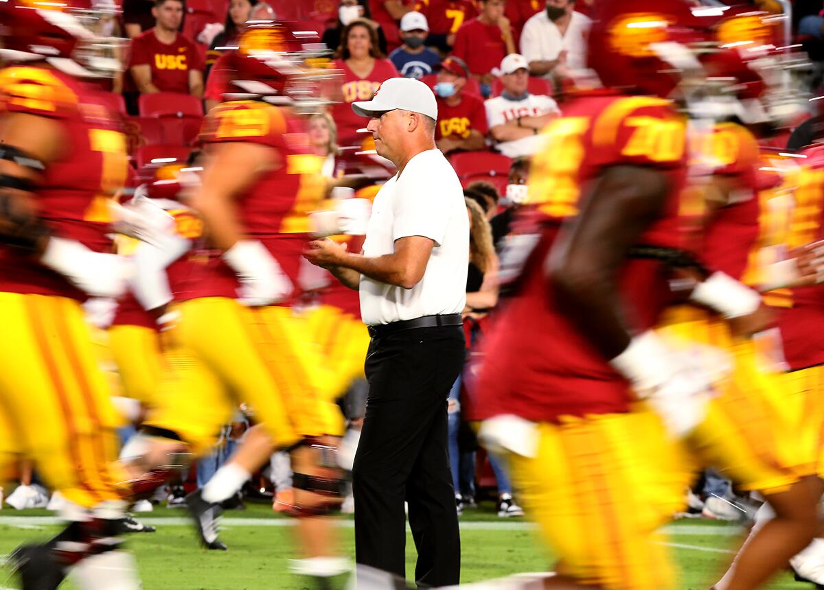 USC coach Clay Helton watches players warm up before Saturday's game against Stanford.