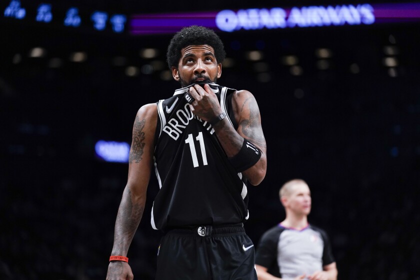 Kyrie Irving looks at the scoreboard during a game between the Brooklyn Nets and the Cleveland Cavaliers in April.