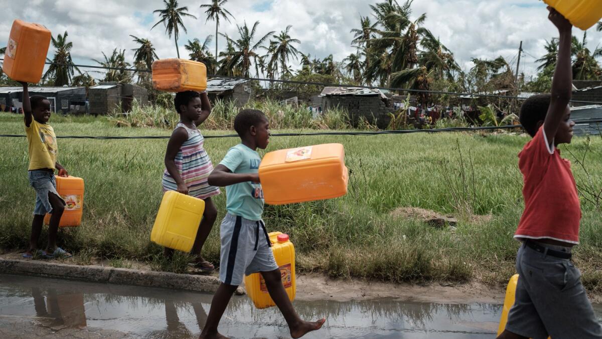 Children carry empty tanks to get water in Beira, Mozambique.
