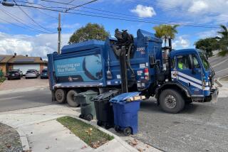 A "blue crew" from Republic Services picks up trash in front of a Chula Vista home Thursday morning.