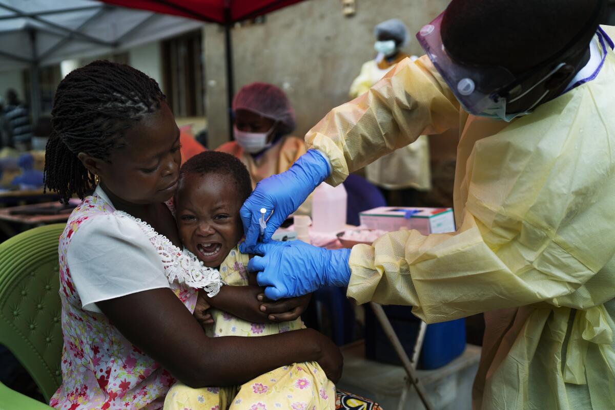FILE - In this Saturday, July 13, 2019 file photo, a child is vaccinated against Ebola in Beni, Congo. The World Health Organization said officials have begun vaccinating people in eastern Congo against Ebola, after it was confirmed last week that the disease killed a toddler. In a statement on Wednesday, Oct. 13, 2021 the U.N. health agency said people at high risk of catching the disease, including the young boy's family members and health workers, would receive the first doses of the vaccine made by Merck.(AP Photo/Jerome Delay, file)