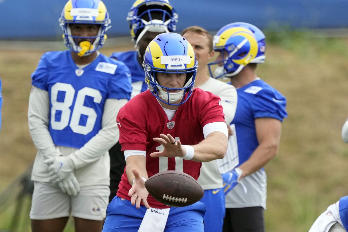 Rams quarterback Brett Rypien takes a snap during organized team activities.