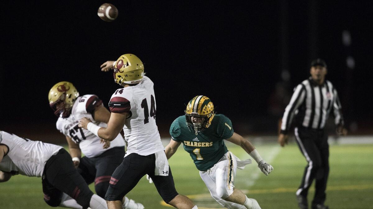 Edison High's Cameron Eden, shown putting pressure on Oaks Christian's Josh Calvert on Nov. 17, 2017, will get to play against Calvert and the Lions for a third time on Friday.