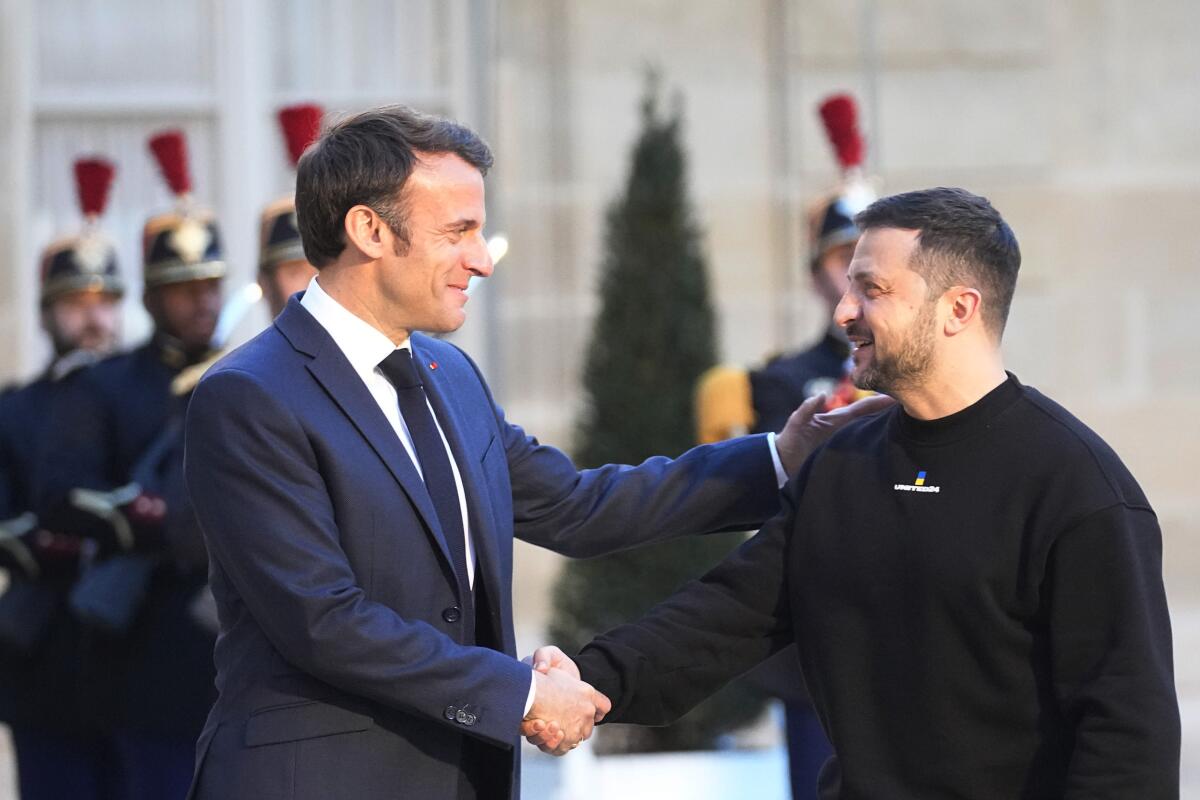 French President Emmanuel Macron welcomes Ukrainian President Volodymyr Zelensky at the Elysee Palace in Paris.