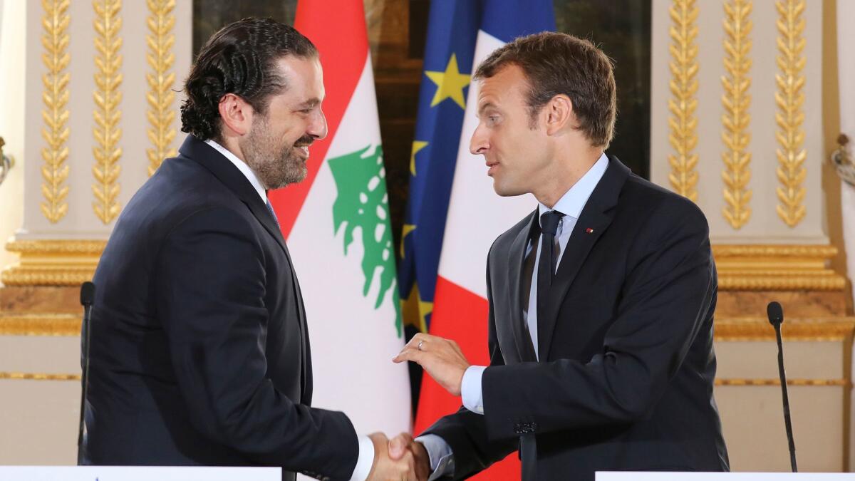 French President Emmanuel Macron, right, shakes hands with Lebanese Prime Minister Saad Hariri during a joint press conference at the Elysee Palace in Paris in September 2017.
