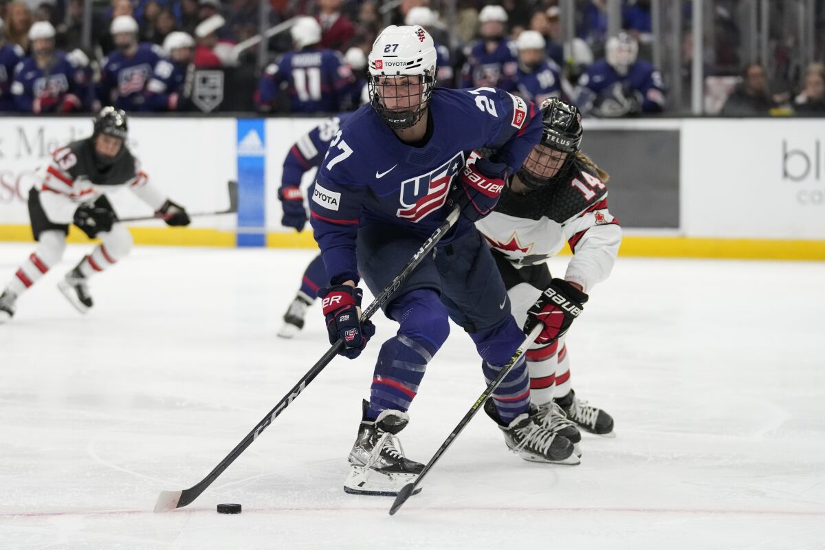 U.S. forward Taylor Heise controls the puck in front of Canada's Renata Fast during the second period.