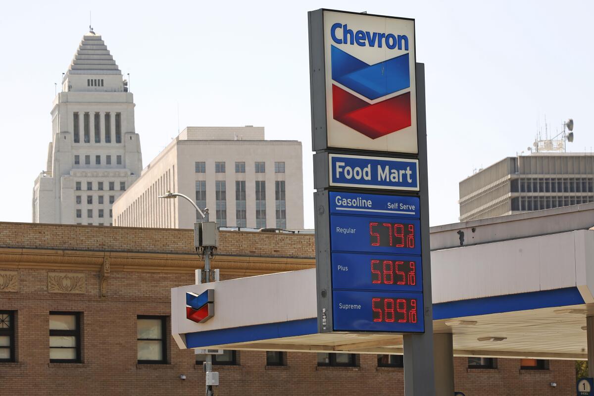 A Chevron gas station, with Los Angeles City Hall in the background.