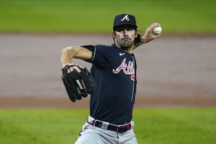 FILE - In this Wednesday, Sept. 16, 2020 file photo, Atlanta Braves starting pitcher Cole Hamels throws a pitch to the Baltimore Orioles during the second inning of a baseball game in Baltimore. Four-time All-Star Cole Hamels signed a one-year contract Wednesday, Aug. 4, 2021 with the Los Angeles Dodgers through the end of the season, adding more depth to a pitching staff that has been racked with injuries.(AP Photo/Julio Cortez, File)