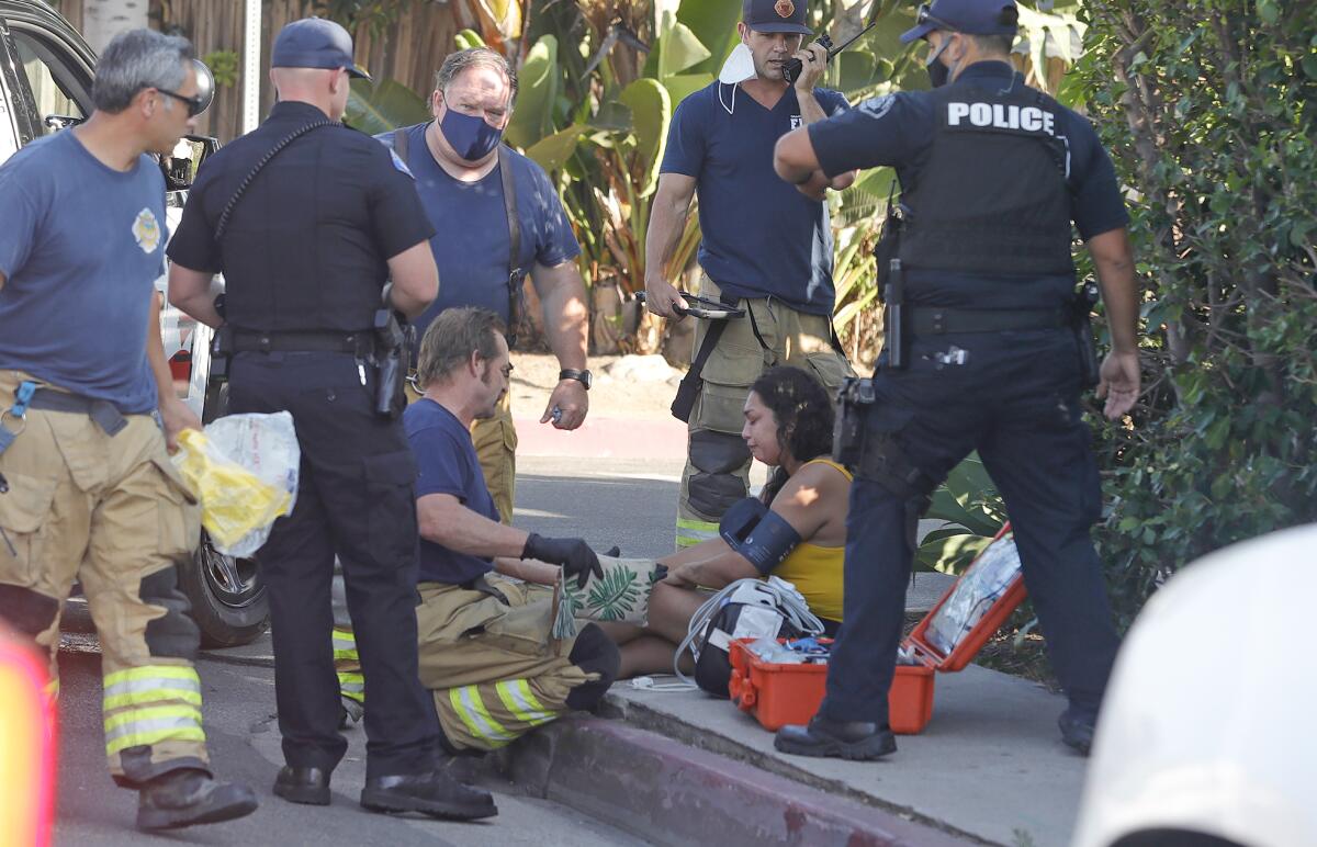 A woman is given medical care by firefighters at Ruby and South Coast Hwy.