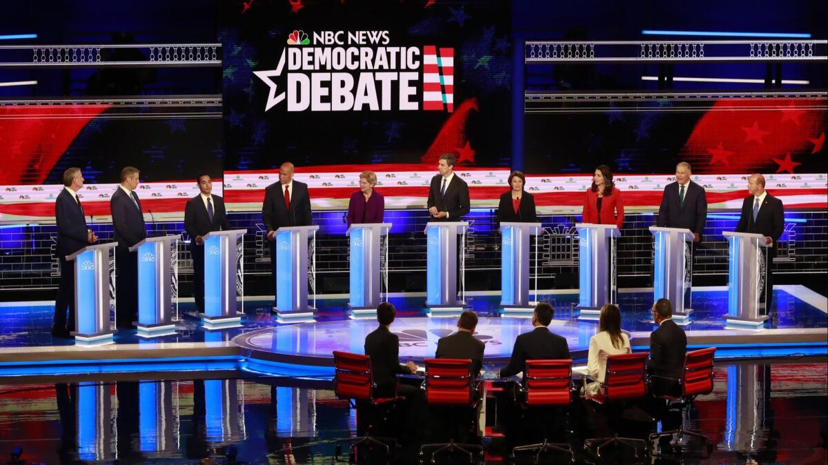 Democratic presidential candidates listen to a question during the Democratic primary debate hosted by NBC News in Miami on June 26.