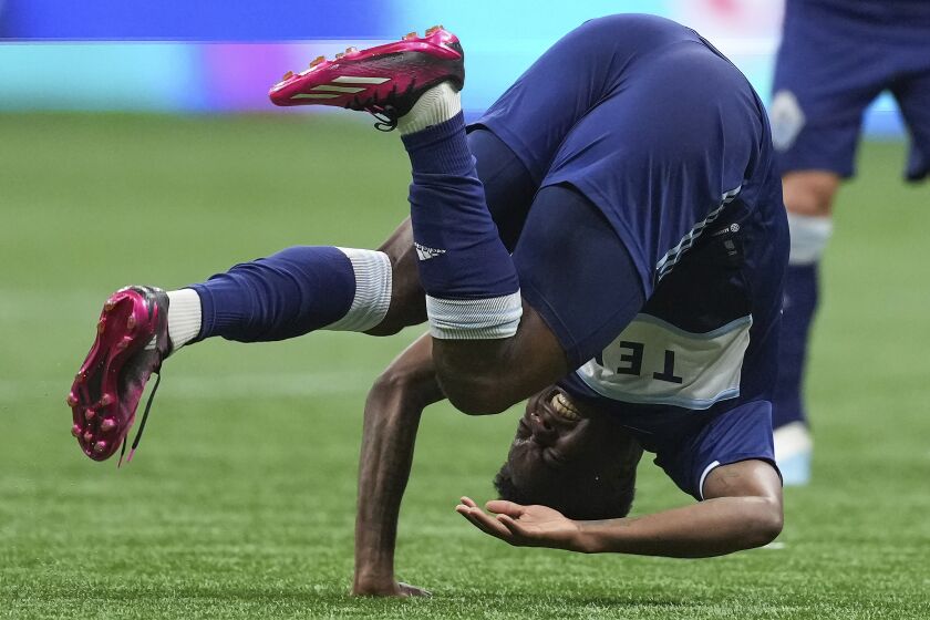 Vancouver Whitecaps' Javain Brown tumbles to the ground after colliding with CF Montreal's Sean Rea during the second half of an MLS soccer match Saturday, April 1, 2023, in Vancouver, British Columbia. (Darryl Dyck/The Canadian Press via AP)