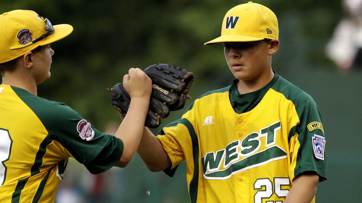 Nick Pratto, right, is congratulated by teammate Dylan Palmer after a 10-0 victory over LaGrange, Ky., at the Little League World Series in 2011.