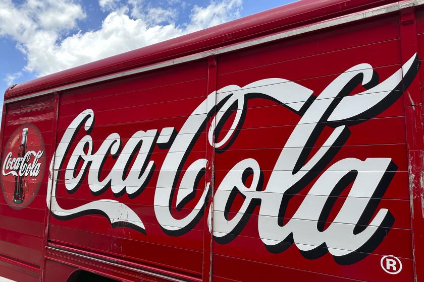 FILE - The Coca-Cola logo adorns the side of a delivery truck May 15, 2024, in southeast Denver. Coca-Cola reports earnings on Tuesday, July 23, 2024. Coca-Cola Co. said Friday, Aug. 2, 2024, it will pay a back tax bill amounting to $6 billion to the Internal Revenue Service while it appeals a federal tax court judge's latest ruling in a case dating back 17 years. (AP Photo/David Zalubowski, File)