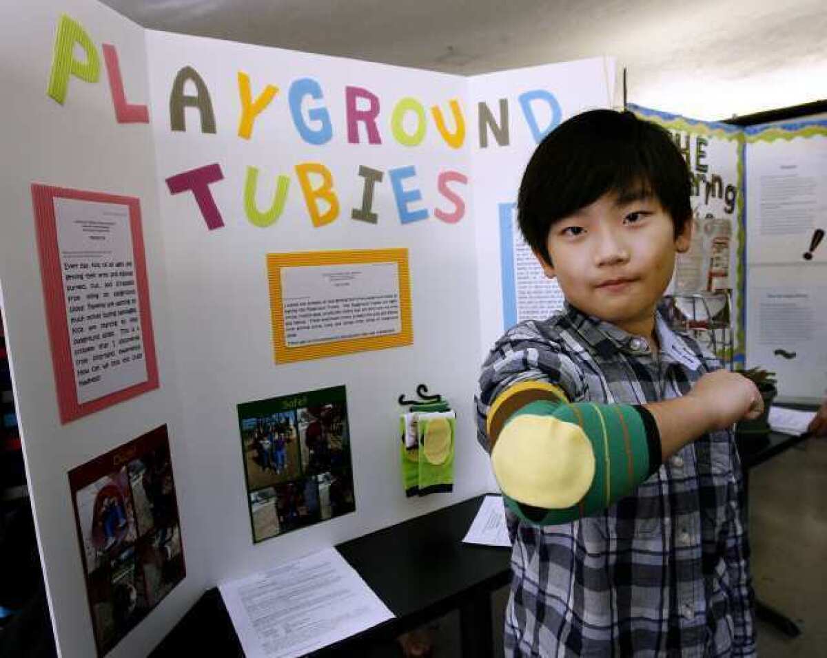 Fremont Elementary School 4th grader Ethan Park shows off his 'Playground Tubies' invention at Glendale Unified School District's 19th annual Invention Convention held at Glendale High School. The tubies keep kids elbows safe in the playground. The convention drew about 122 projects from 4th through 7th grade students.