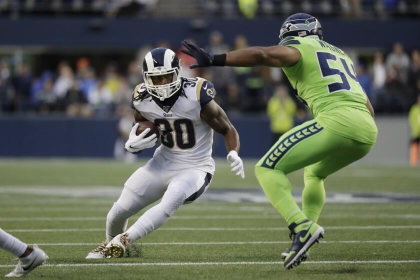 Los Angeles Rams running back Todd Gurley, left, squares off against Seattle Seahawks middle linebacker Bobby Wagner during the first half of an NFL football game Thursday, Oct. 3, 2019, in Seattle. (AP Photo/Elaine Thompson)