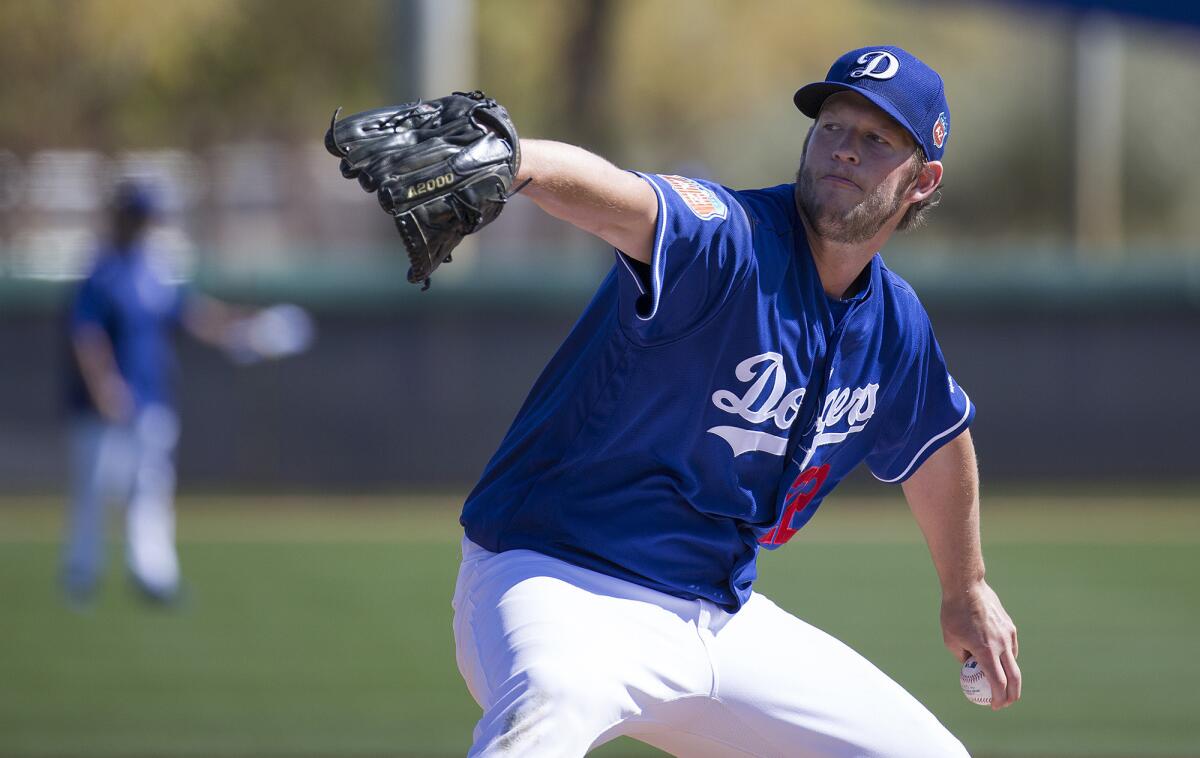 Dodgers ace Clayton Kershaw warms up during a spring workout on Friday in Glendale, Ariz.