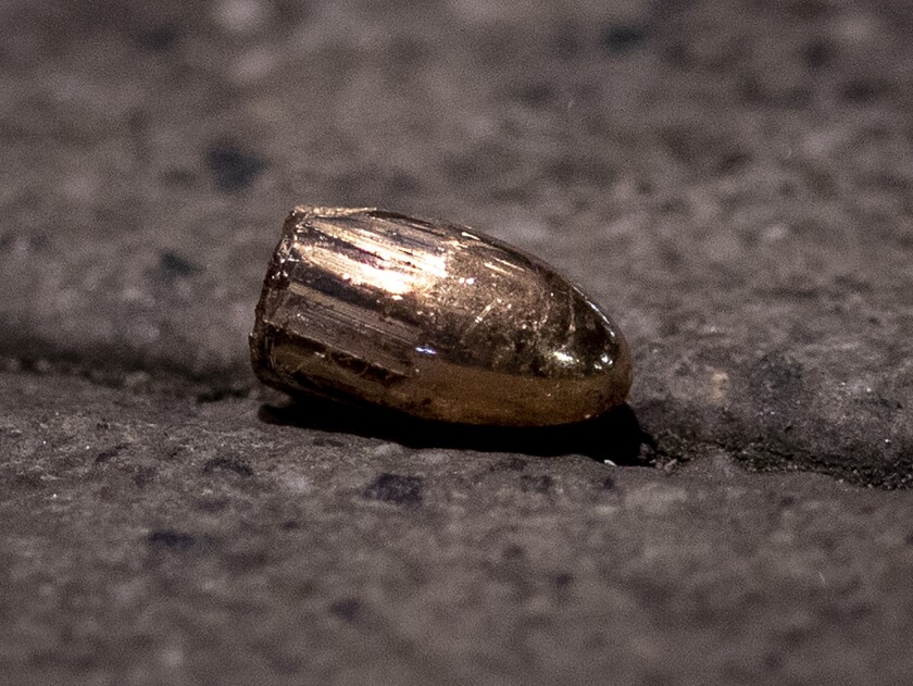 FILE - In this Feb. 19, 2020 file photo, a projectile lies on the sidewalk near a restaurant at the scene of a shooting in central Hanau, Germany. About one year ago a far right man shot nine people before he shot himself. Hanau will commemorate the victims this Friday. (AP Photo/Michael Probst, File)