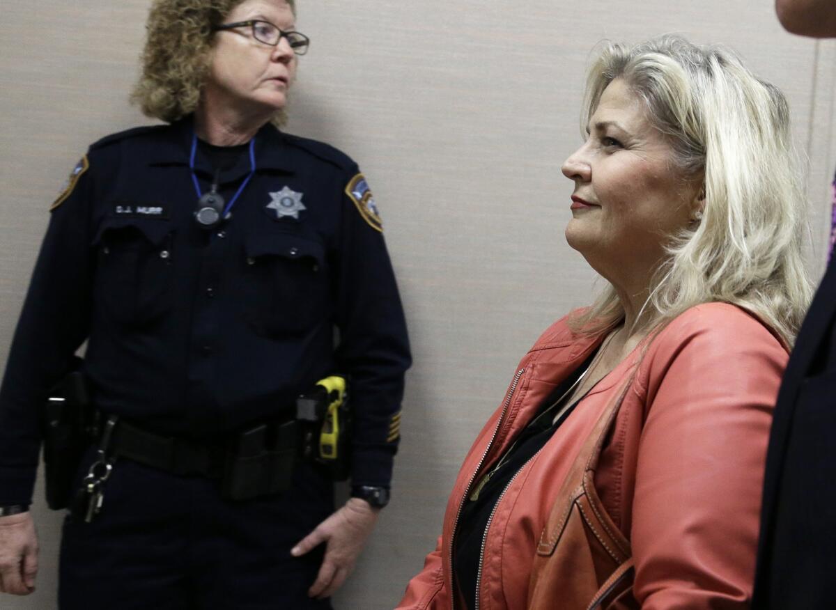 Sandra Merritt, one of the two antiabortion activists indicted last week, leaves a Houston courtroom after turning herself in to authorities Wednesday. Merritt and David Daleiden are charged with tampering with a governmental record, a felony punishable by up to 20 years in prison.