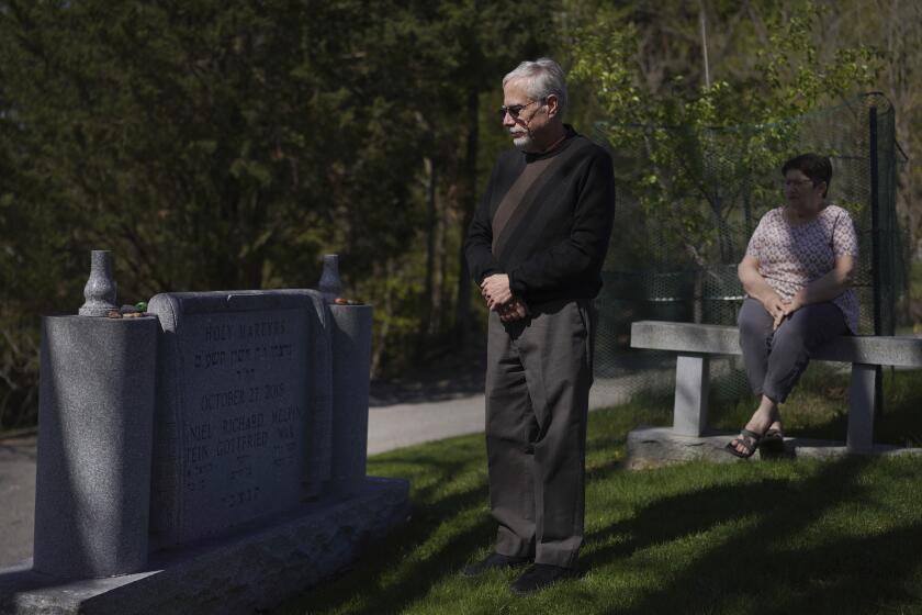 Co-presidents of New Light Congregation, Stephen Cohen and Barbara Caplan, visit a memorial in the New Light Cemetery on Wednesday, April 19, 2023, in Shaler Township, Pa., honoring the congregants they lost during the Pittsburgh synagogue massacre over four years ago. Jury selection is scheduled to begin on Monday, April 24, for the suspect accused of invading the Tree of Life synagogue building on that Sabbath morning and murdering 11 worshippers from three congregations. (AP Photo/Jessie Wardarski)