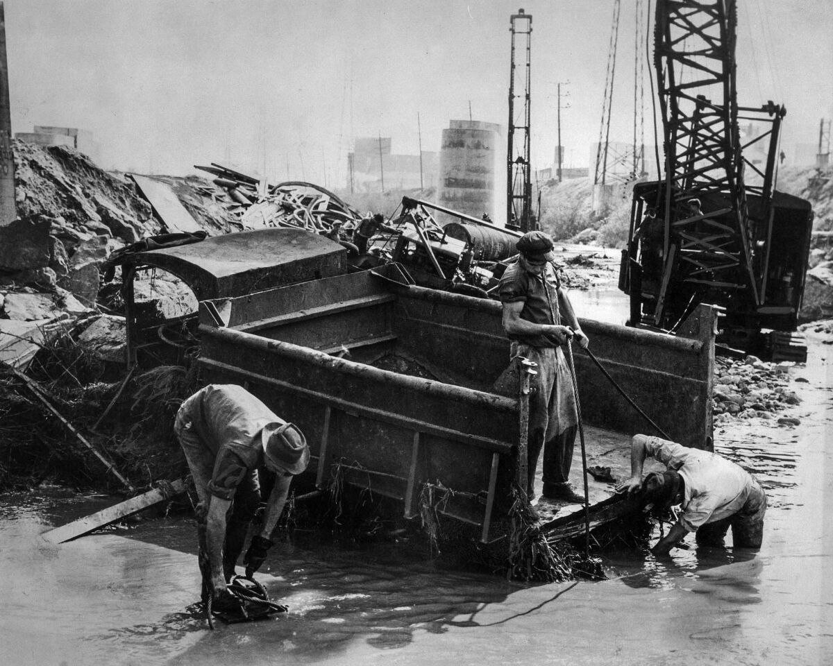 March 2, 1938: Salvage crew digs out a gravel truck that was mired in mud along the Los Angeles River.