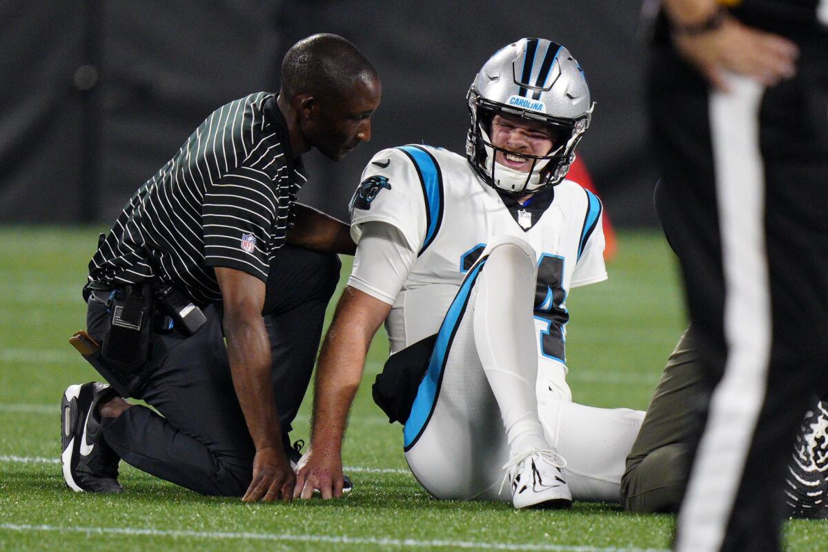 Carolina Panthers quarterback Sam Darnold is treated after getting injured during the second half of an NFL preseason football game against the Buffalo Bills on Friday, Aug. 26, 2022, in Charlotte, N.C. (AP Photo/Jacob Kupferman)