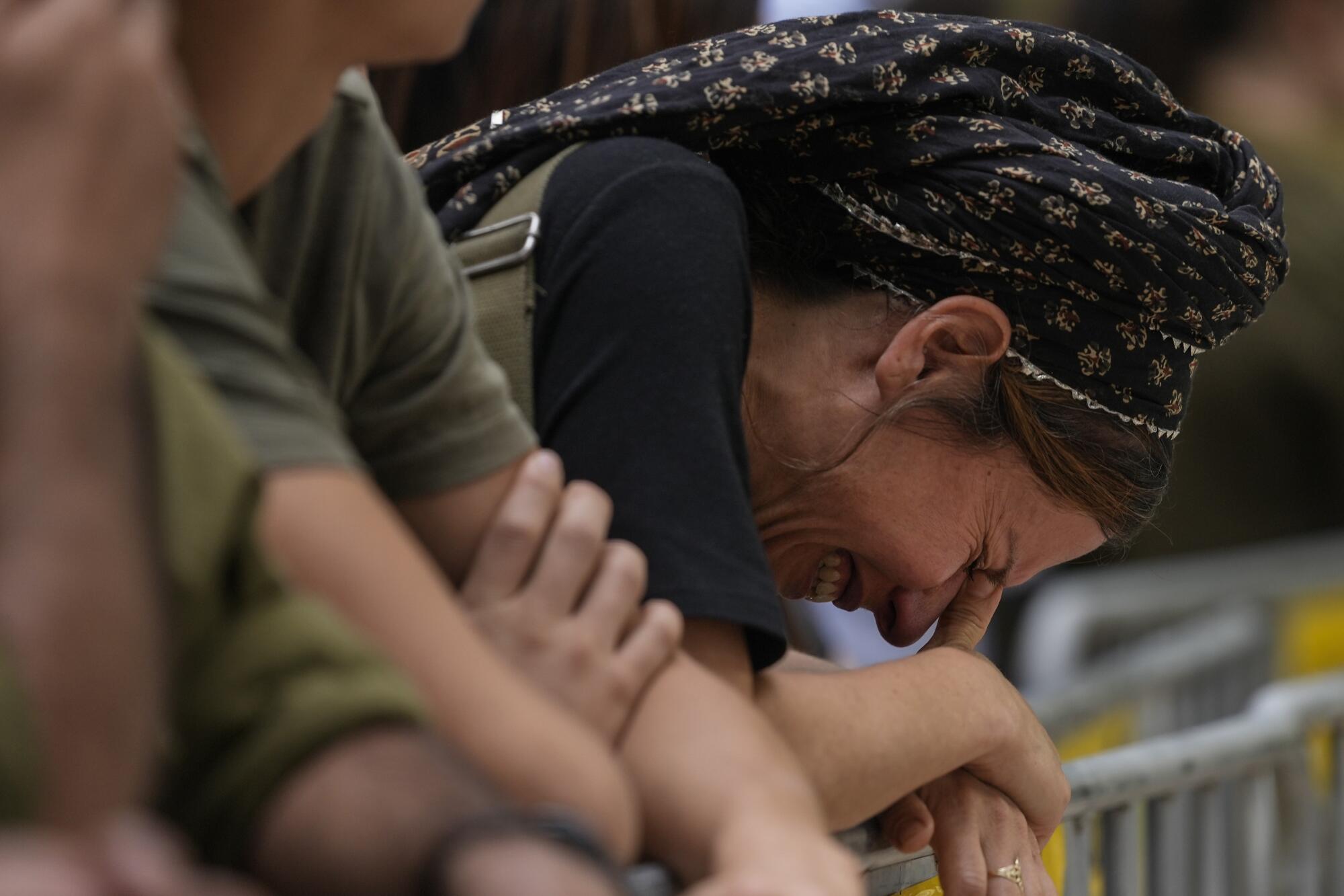 A woman cries during the funeral of Israeli Col. Roi Levy at the Mount Herzl cemetery in Jerusalem.