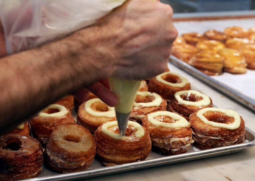 Chef Dominique Ansel makes Cronuts, croissant-donut hybrids, at his bakery in New York.