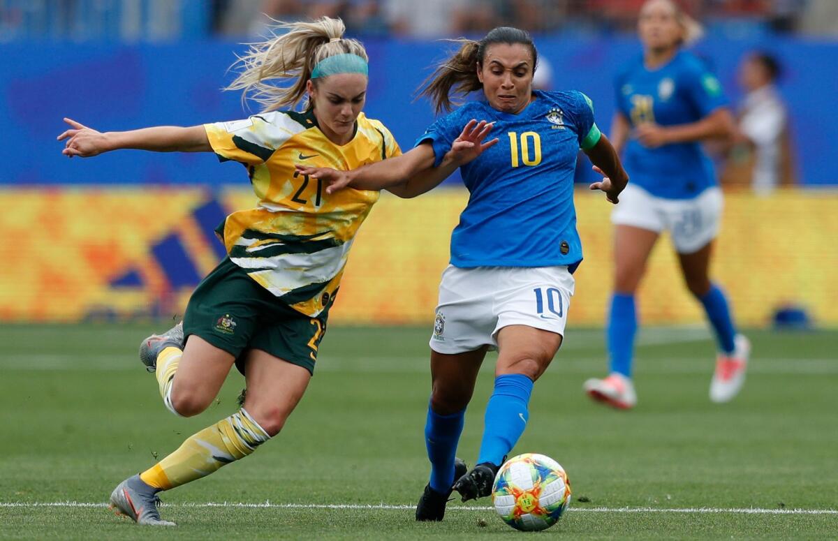Brazil's Marta, right, tries to get past Australia's Ellie Carpentier during a Women's World Cup match Thursday in Montpellier, France.