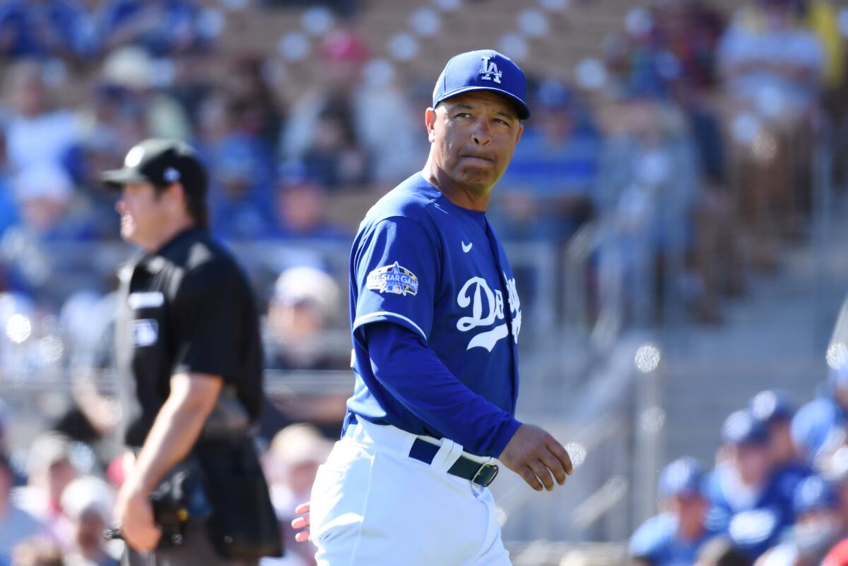 Dodgers manager Dave Roberts looks on during a spring training game at Camelback Ranch on Feb. 26.