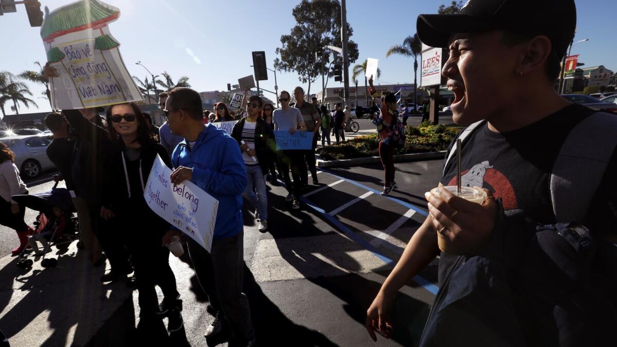 My Nguyen, 24, right, shouts slogans at the protest Saturday in Westminster.