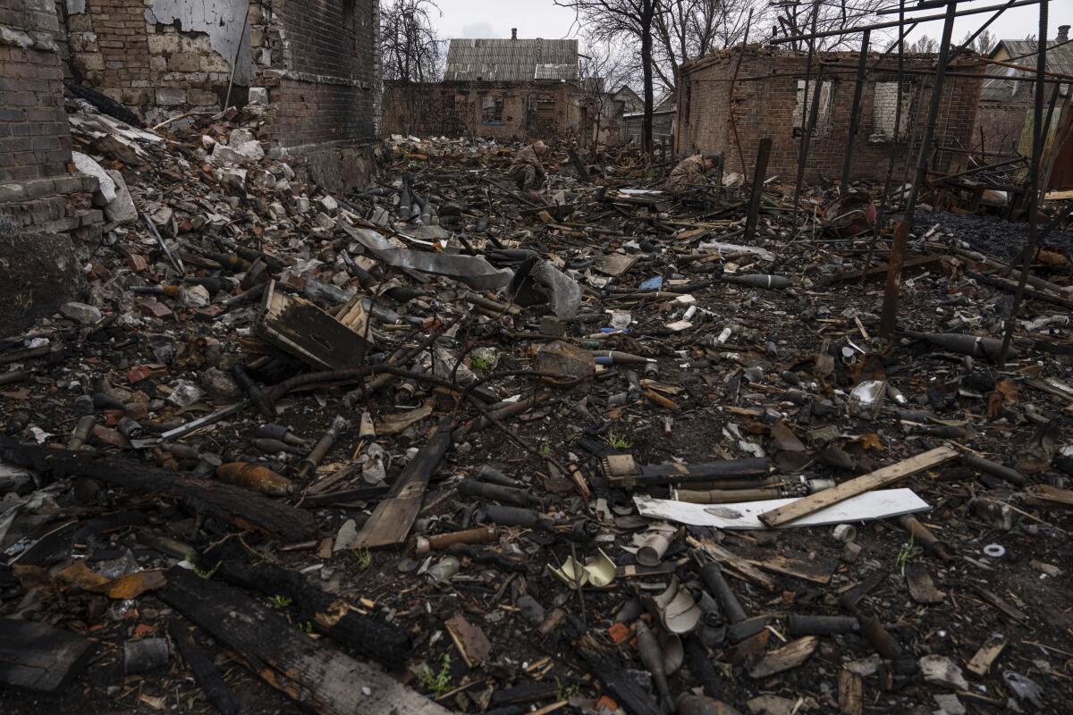 Piles of soot-covered debris cover the ground in Ukraine.