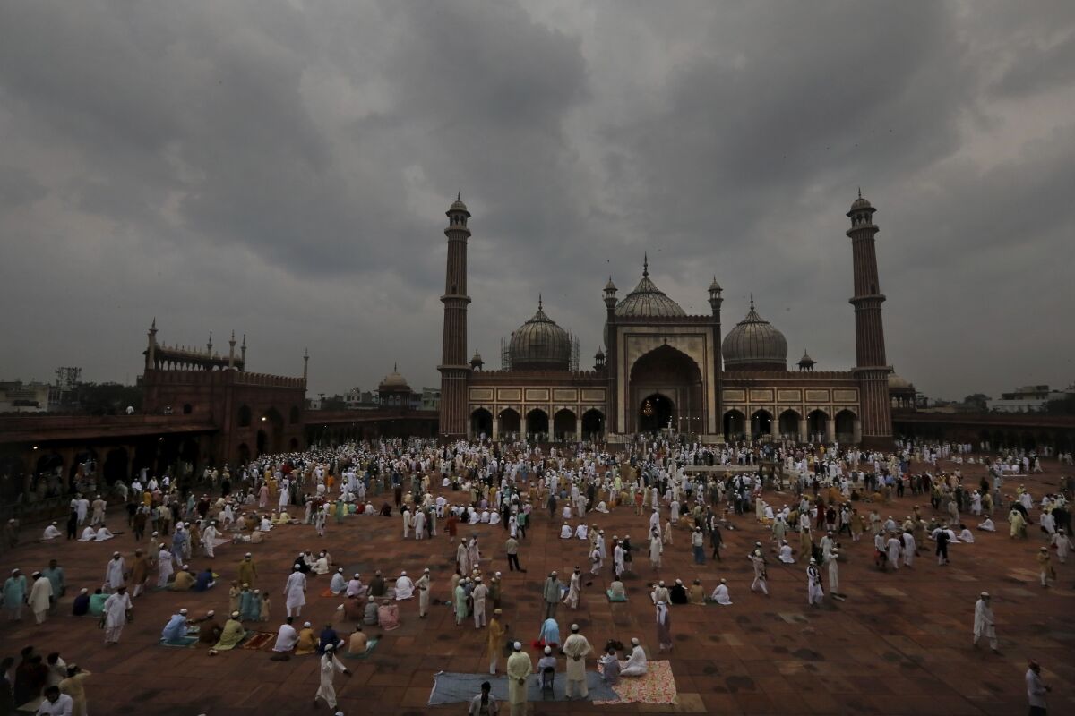 Indian Muslims wait as others leave after offering Eid al-Adha prayer at the Jama Masjid in New Delhi, India, Saturday, Aug.1, 2020. Eid al-Adha, or the Feast of the Sacrifice, by sacrificing animals to commemorate the prophet Ibrahim's faith in being willing to sacrifice his son. (AP Photo/Manish Swarup)