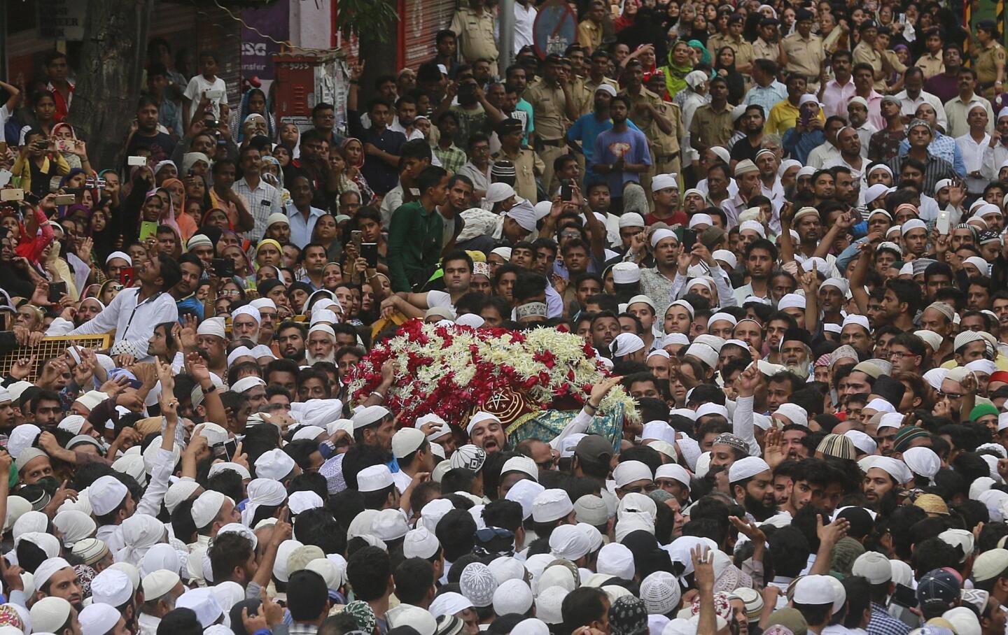 People carry the body of Yakub Memon outside his family residence during his funeral in Mumbai, India, on July 30. Memon was executed for his role in the 1993 Mumbai bombings in which 13 bombs ripped through hotels, bazaars and the stock exchange in India’s financial capital.
