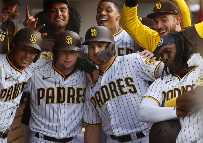 San Diego Padres players surround Brandon Drury, center, for a photo after he hit a grand slam
